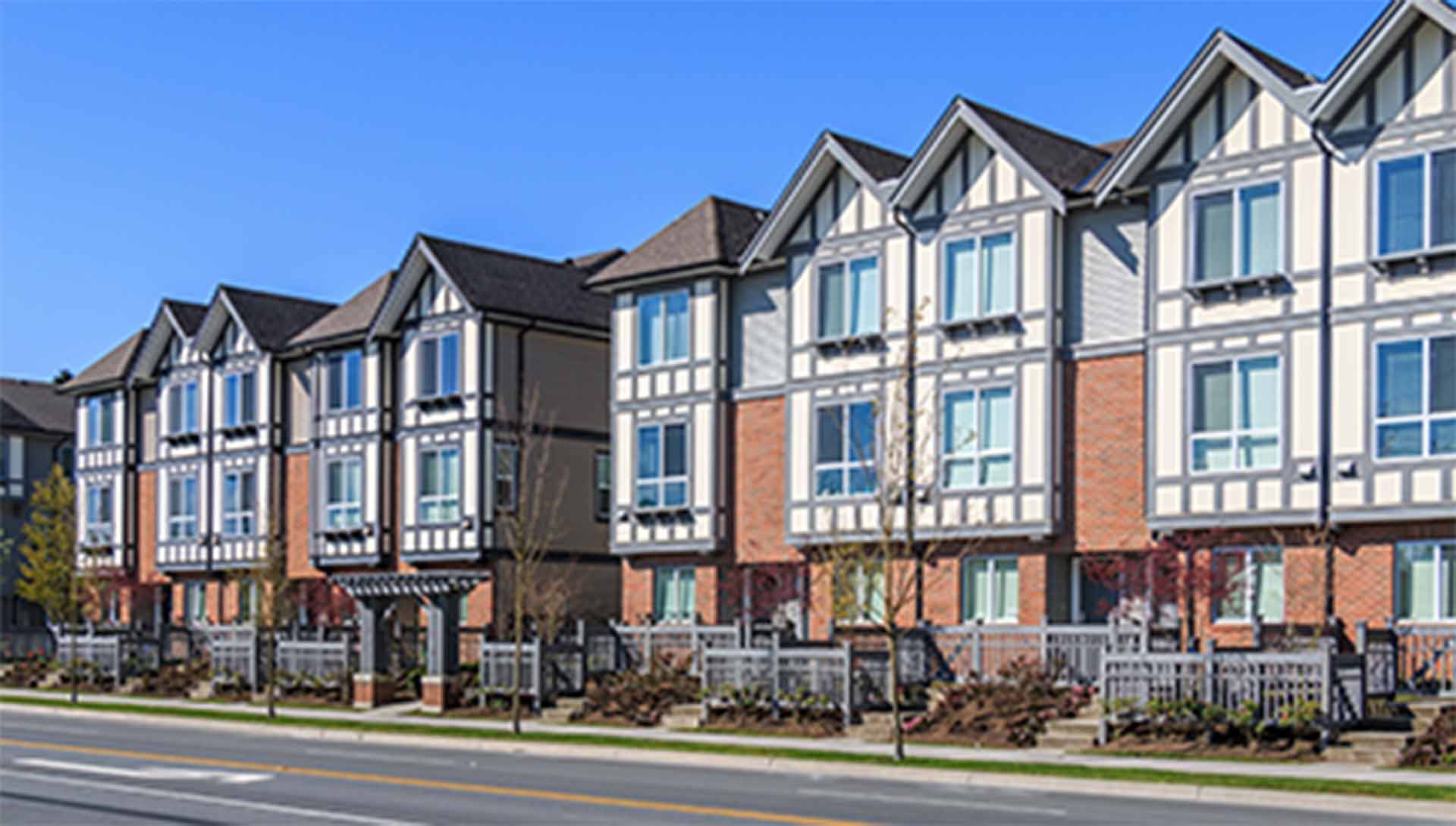 A photo of a row of town home condos that have Northern Comfort Windows and Doors Installed.