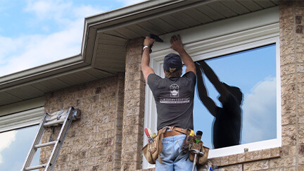A Northern Comfort Installer Installing a second story window.